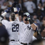 
              New York Yankees' Aaron Judge celebrates with Josh Donaldson (28) after hitting his 60th home run of the season, during the ninth inning of the team's baseball game against the Pittsburgh Pirates on Tuesday, Sept. 20, 2022, in New York. (AP Photo/Jessie Alcheh)
            
