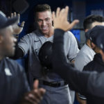 
              New York Yankees' Aaron Judge smiles in the dugout after hitting his 61st home run of the season, a two-run shot, against the Toronto Blue Jays during the seventh inning of a baseball game Wednesday, Sept. 28, 2022, in Toronto. (Nathan Denette/The Canadian Press via AP)
            