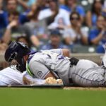 
              Chicago Cubs' Alfonso Rivas, , left, is tagged out at home plate by Colorado Rockies catcher Elias Diaz, right, during the fifth inning of a baseball game Saturday, Sept. 17, 2022, in Chicago. (AP Photo/Paul Beaty)
            