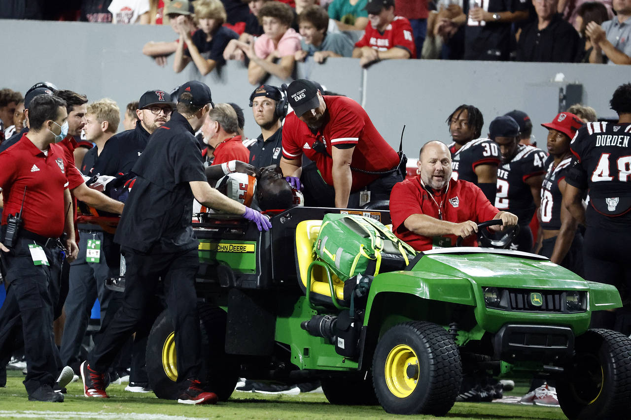 Texas Tech's Bryce Ramirez (54) is carted off the field by medical staff following suffering an unk...