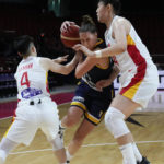 
              Bosnia and Herzegovina's Andela Delic, centre, attempts to run past China's Li Yueru, right, and China's Yuan Li, left, during their game at the women's Basketball World Cup in Sydney, Australia, Friday, Sept. 23, 2022. (AP Photo/Mark Baker)
            