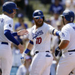 
              Los Angeles Dodgers' Justin Turner, center, celebrates his three-run home run at home plate with Max Muncy (13) and Freddie Freeman (5) during the fifth inning of a baseball game against the San Francisco Giants Wednesday, Sept. 7, 2022, in Los Angeles. (AP Photo/Marcio Jose Sanchez)
            