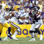 
              LSU quarterback Jayden Daniels (5)) runs the ball past Mississippi State defensive tackle Cameron Young (93) during the first half of an NCAA college football game in Baton Rouge, La., Saturday, Sept. 17, 2022. (AP Photo/Tyler Kaufman)
            