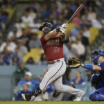 
              Arizona Diamondbacks designated hitter Christian Walker (53) hits a home run during the ninth inning of a baseball game against the Los Angeles Dodgers in Los Angeles, Thursday, Sept. 22, 2022. (AP Photo/Ashley Landis)
            