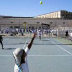 
              James Duff, bottom, serves during a tennis match between fellow San Quentin State Prison inmates and visiting players in San Quentin, Calif., Saturday, Aug. 13, 2022. (AP Photo/Godofredo A. Vásquez)
            