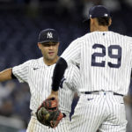 
              New York Yankees' Isiah Kiner-Falefa celebrates with Ronald Guzman (29) after the Yankees defeated the Minnesota Twins 7-1 in the second baseball game of a doubleheader Wednesday, Sept. 7, 2022, in New York. (AP Photo/Adam Hunger)
            
