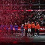 
              Team World's members celebrate with the trophy, watched by Australian tennis legend Rod Laver and members of Team Europe at the end of the Laver Cup tennis tournament in London, Sunday, Sept. 25, 2022. (AP Photo/Kin Cheung)
            