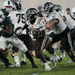 
              Western Michigan running back Sean Tyler rushes during the second half of an NCAA college football game against Michigan State, Friday, Sept. 2, 2022, in East Lansing, Mich. (AP Photo/Carlos Osorio)
            