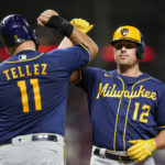 
              Milwaukee Brewers' Hunter Renfroe (12) celebrates with Rowdy Tellez (11) after hitting a two-run home run during the fifth inning of a baseball game against the Cincinnati Reds, Saturday, Sept. 24, 2022, in Cincinnati. (AP Photo/Jeff Dean)
            