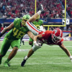 
              Georgia wide receiver Ladd McConkey (84) is defended by Oregon defensive lineman Treven Ma'ae (48) as he dives for the goal line after a catch in the first half of an NCAA college football game Saturday, Sept. 3, 2022, in Atlanta. McConkey didn't not score on the play. (AP Photo/John Bazemore)
            