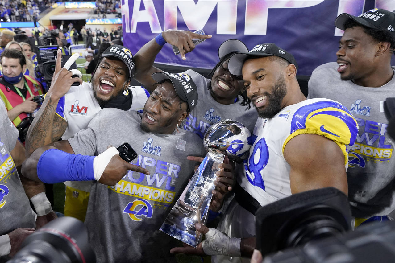 FILE - Los Angeles Rams players celebrate with the Lombardi Trophy after defeating the Cincinnati B...