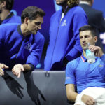 
              Team Europe's Novak Djokovic, right, listens to Roger Federer during a match against Team World's Frances Tiafoe on second day of the Laver Cup tennis tournament at the O2 in London, Saturday, Sept. 24, 2022. (AP Photo/Kin Cheung)
            