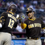 
              San Diego Padres' Juan Soto, right, celebrates his home run against the Arizona Diamondbacks with Padres' Manny Machado (13) during the fifth inning of a baseball game in Phoenix, Sunday, Sept. 18, 2022. (AP Photo/Ross D. Franklin)
            