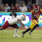 
              Southern California wide receiver Jordan Addison, right, runs the ball as Fresno State linebacker Raymond Scott attempts a tackle during the first half of an NCAA college football game Saturday, Sept. 17, 2022, in Los Angeles. (AP Photo/Mark J. Terrill)
            