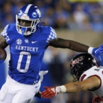 
              Kentucky running back Kavosiey Smoke (0) stiff-arms Northern Illinois linebacker Nick Rattin (38) during the second half of an NCAA college football game in Lexington, Ky., Saturday, Sept. 24, 2022. (AP Photo/Michael Clubb)
            