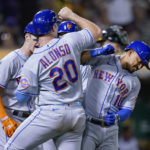 
              New York Mets' Eduardo Escobar, right, celebrates with Pete Alonso after hitting a grand slam against the Oakland Athletics during the fifth inning of a baseball game in Oakland, Calif., Friday, Sept. 23, 2022. (AP Photo/Godofredo A. Vásquez)
            