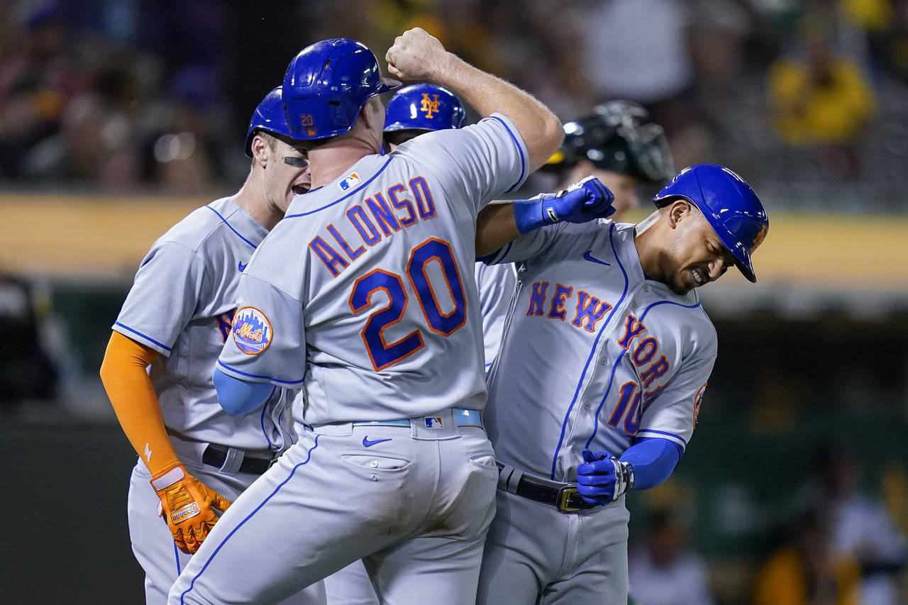 New York Mets' Eduardo Escobar, right, celebrates with Pete Alonso after hitting a grand slam again...