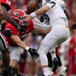 
              Samford quarterback Michael Hiers (10) fumbles as he is hit by Georgia defensive back Dan Jackson (17) during the first half of an NCAA college football game, Saturday, Sept. 10, 2022 in Athens, Ga. (AP Photo/John Bazemore)
            