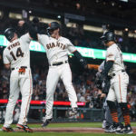 
              San Francisco Giants' Ford Proctor, second from left, celebrates with Austin Wynns after hitting a grand slam against the Colorado Rockies during the second inning of a baseball game in San Francisco, Thursday, Sept. 29, 2022. (AP Photo/Godofredo A. Vásquez)
            