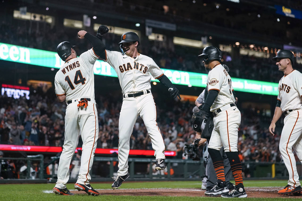San Francisco Giants' Ford Proctor, second from left, celebrates with Austin Wynns after hitting a ...