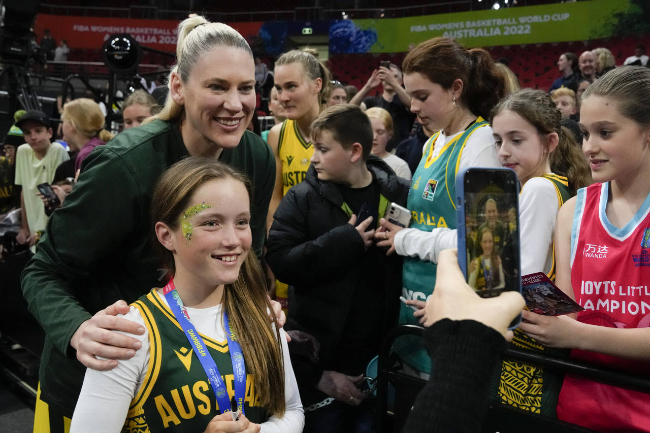 Australia's Lauren Jackson poses for a selfie with a young fan following their win over Japan at th...