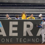 
              Chicago Cubs left fielder Ian Happ bumps into the wall as the home run by Pittsburgh Pirates' Kevin Newman flies into the bleachers past fans during the seventh inning of a baseball game Thursday, Sept. 22, 2022, in Pittsburgh. (AP Photo/Keith Srakocic)
            