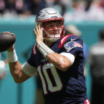 
              New England Patriots quarterback Mac Jones (10) aims a pass during the first half of an NFL football game against the Miami Dolphins, Sunday, Sept. 11, 2022, in Miami Gardens, Fla. (AP Photo/Rebecca Blackwell)
            