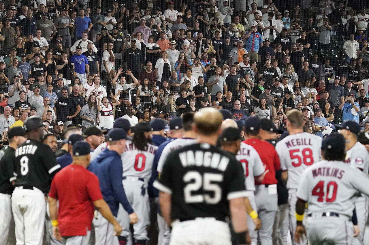 Fans stand as the benches clear after Chicago White Sox's Andrew Vaughn (25) was hit by pitch from ...