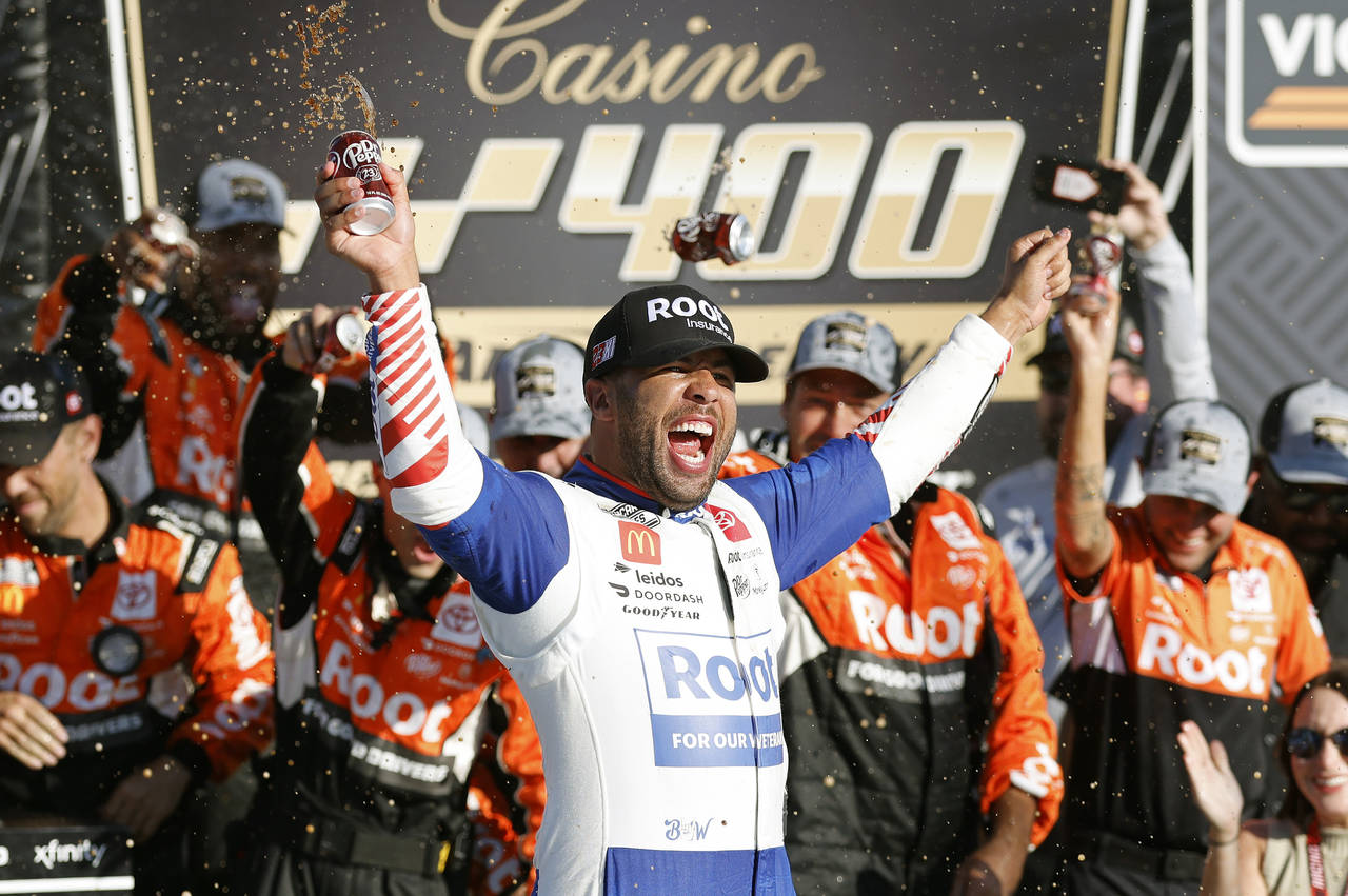 Bubba Wallace celebrates in Victory Lane after winning a NASCAR Cup Series auto race at Kansas Spee...