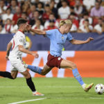 
              Manchester City's Erling Haaland, right, attempts a shot during the group G Champions League soccer match between Sevilla and Manchester City in Seville, Spain, Tuesday, Sept. 6, 2022. (AP Photo/Jose Breton)
            