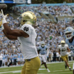
              Notre Dame wide receiver Lorenzo Styles (4) hauls in a touchdown pass against North Carolina defensive back Cam'Ron Kelly (9) during the first half of an NCAA college football game in Chapel Hill, N.C., Saturday, Sept. 24, 2022 (AP Photo/Chris Seward)
            