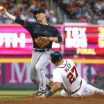 
              Atlanta Braves' Austin Riley is out at second base as Miami Marlins' Joey Wendle turns a double play to end the first inning of a baseball game Saturday, Sept. 3, 2022, in Atlanta. (AP Photo/Bob Andres)
            