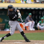 
              Chicago White Sox's AJ Pollock hits an RBI-single against the Oakland Athletics during the sixth inning of a baseball game in Oakland, Calif., Sunday, Sept. 11, 2022. (AP Photo/Godofredo A. Vásquez)
            
