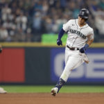 
              Seattle Mariners' Sam Haggerty, right, rounds the bases after hitting a solo home run on a pitch from Atlanta Braves starting pitcher Max Fried during the fifth inning of a baseball game, Saturday, Sept. 10, 2022, in Seattle. (AP Photo/John Froschauer)
            