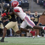 
              Wake Forest wide receiver Ke'Shawn Williams runs after a catch as Liberty safety Quinton Reese defends during the first half of an NCAA college football game in Winston-Salem, N.C., Saturday, Sept. 17, 2022. (AP Photo/Chuck Burton)
            