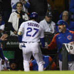 
              Chicago Cubs' Seiya Suzuki (27) celebrates with manager Davis Ross, right, at the dugout after hitting a solo home run during the eighth inning of a baseball game against the San Francisco Giants Sunday, Sept. 11, 2022, in Chicago. (AP Photo/Paul Beaty)
            