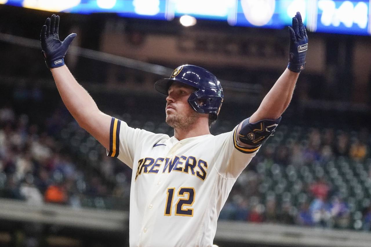 Milwaukee Brewers' Hunter Renfroe reacts after hitting an RBI single during the third inning of a b...