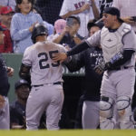 
              New York Yankees' Gleyber Torres (25) is congratulated by teammates after scoring on a throwing error by Boston Red Sox catcher Connor Wong, after driving in Aaron Judge and Aaron Hicks on a single, during the fifth inning of a baseball game at Fenway Park, Wednesday, Sept. 14, 2022, in Boston. (AP Photo/Charles Krupa)
            