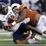
              UTSA quarterback Frank Harris, left, is hit by Texas defensive lineman Alfred Collins (95) during the first half of an NCAA college football game, Saturday, Sept. 17, 2022, in Austin, Texas. (AP Photo/Eric Gay)
            