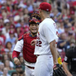 
              St. Louis Cardinals catcher Yadier Molina, left, smiles as he walks off the field with starting pitcher Jack Flaherty after retiring the Washington Nationals during the fourth inning of a baseball game Monday, Sept. 5, 2022, in St. Louis. (AP Photo/Jeff Roberson)
            