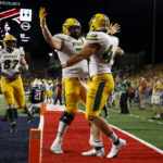 
              North Dakota State fullback Hunter Luepke (44) hugs offensive tackle Cody Mauch after scoring a touchdown against Arizona during the second half of an NCAA college football game Saturday, Sept. 17, 2022, in Tucson, Ariz. (AP Photo/Chris Coduto)
            