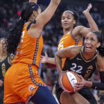 
              Las Vegas Aces forward A'ja Wilson (22) looks for a shot between Connecticut Sun center Brionna Jones (42) and forward Alyssa Thomas (25) during the first half in Game 1 of a WNBA basketball final playoff series Sunday, Sept. 11, 2022, in Las Vegas. (AP Photo/L.E. Baskow)
            