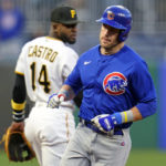 
              Chicago Cubs' Patrick Wisdom, right, rounds third past Pittsburgh Pirates third baseman Rodolfo Castro (14) after hitting a two-run home run off Pirates starting pitcher Bryse Wilson during the second inning of a baseball game in Pittsburgh, Friday, Sept. 23, 2022. (AP Photo/Gene J. Puskar)
            