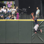 
              Atlanta Braves centerfielder Michael Harris II climbs the outfield wall in an attempt to get to a home run ball hit by Seattle Mariners' Eugenio Suarez during the fifth inning of a baseball game, Sunday, Sept. 11, 2022, in Seattle. (AP Photo/Stephen Brashear)
            