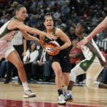
              Las Vegas Aces guard Kelsey Plum (10) drives between Seattle Storm forward Stephanie Talbot, left, and guard Jewell Loyd during the first half in Game 2 of a WNBA basketball semifinal playoff series Wednesday, Aug. 31, 2022, in Las Vegas. (AP Photo/John Locher)
            