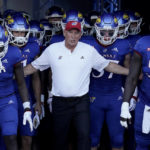 
              Kansas head coach Lance Leipold leads his team onto the field before an NCAA college football game against Tennessee Tech Friday, Sept. 2, 2022, in Lawrence, Kan. (AP Photo/Charlie Riedel)
            