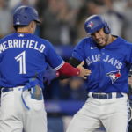 
              Toronto Blue Jays' George Springer, right, celebrates his two-run home run against the Tampa Bay Rays with Whit Merrifield (1) during the seventh inning of the second baseball game of a doubleheader Tuesday, Sept. 13, 2022, in Toronto. (Frank Gunn/The Canadian Press via AP)
            