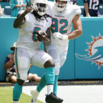 
              Miami Dolphins defensive tackle Zach Sieler (92) celebrates linebacker Melvin Ingram (6) after Ingram recovered a fumble and ran for a touchdown during the first half of an NFL football game against the New England Patriots, Sunday, Sept. 11, 2022, in Miami Gardens, Fla. (AP Photo/Lynne Sladky)
            