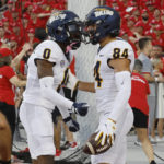 
              Toledo receiver Thomas Zsiros, right, celebrates his touchdown against Ohio State with receiver DeMeer Blankumsee during the first half of an NCAA college football game Saturday, Sept. 17, 2022, in Columbus, Ohio. (AP Photo/Jay LaPrete)
            