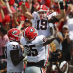 
              Georgia tight end Brock Bowers gets a hoist in the endzone by offensive lineman Amarius Mims after scoring his second touchdown of the first half of an NCAA college football game against South Carolina Saturday, Sept. 17, 2022, in Columbia, S.C. (Curtis Compton/Atlanta Journal-Constitution via AP)
            